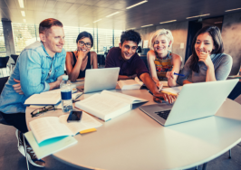 peple at the desk laughing, members of Your English Success Club